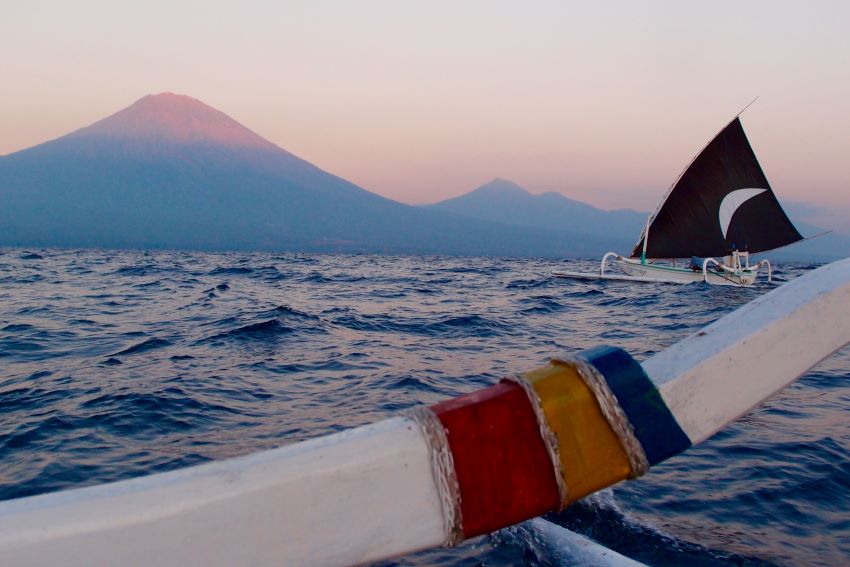 boat with vulcano on the horizon
